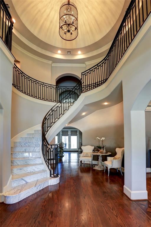 Design ideas for a large mediterranean marble curved staircase in Houston with marble risers and metal railing.