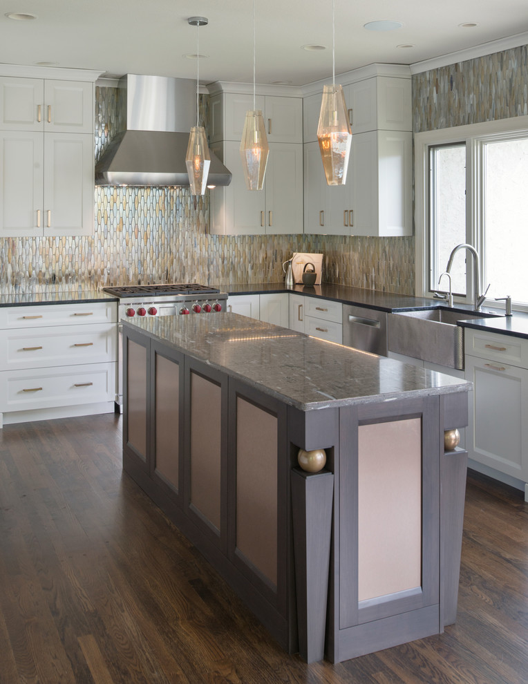 Inspiration for a large transitional l-shaped kitchen pantry in Kansas City with a farmhouse sink, shaker cabinets, white cabinets, metal splashback, stainless steel appliances, dark hardwood floors, with island, brown floor and metallic splashback.
