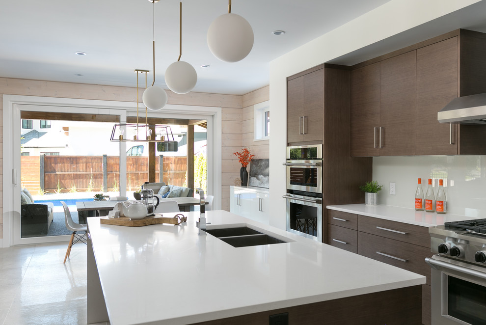 This is an example of a mid-sized modern l-shaped open plan kitchen in Other with a double-bowl sink, flat-panel cabinets, dark wood cabinets, quartzite benchtops, white splashback, stainless steel appliances, with island and white floor.