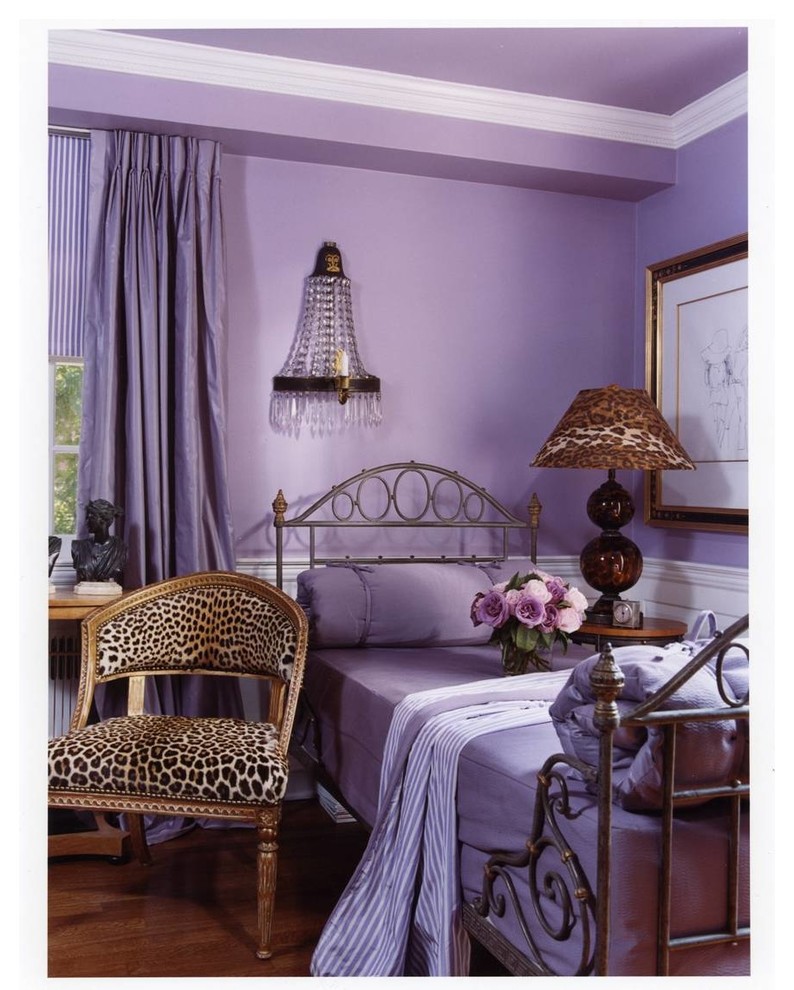 Photo of an eclectic bedroom in DC Metro with purple walls and medium hardwood floors.