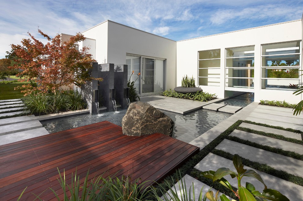 Inspiration for a contemporary garden in Sydney with a water feature and decking.