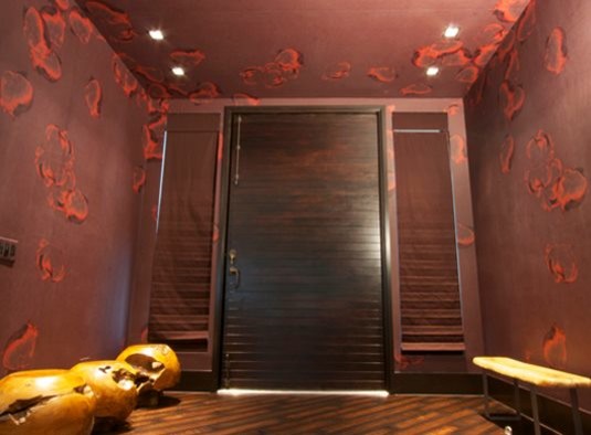 Foyer - mid-sized transitional medium tone wood floor foyer idea in Houston with brown walls and a brown front door