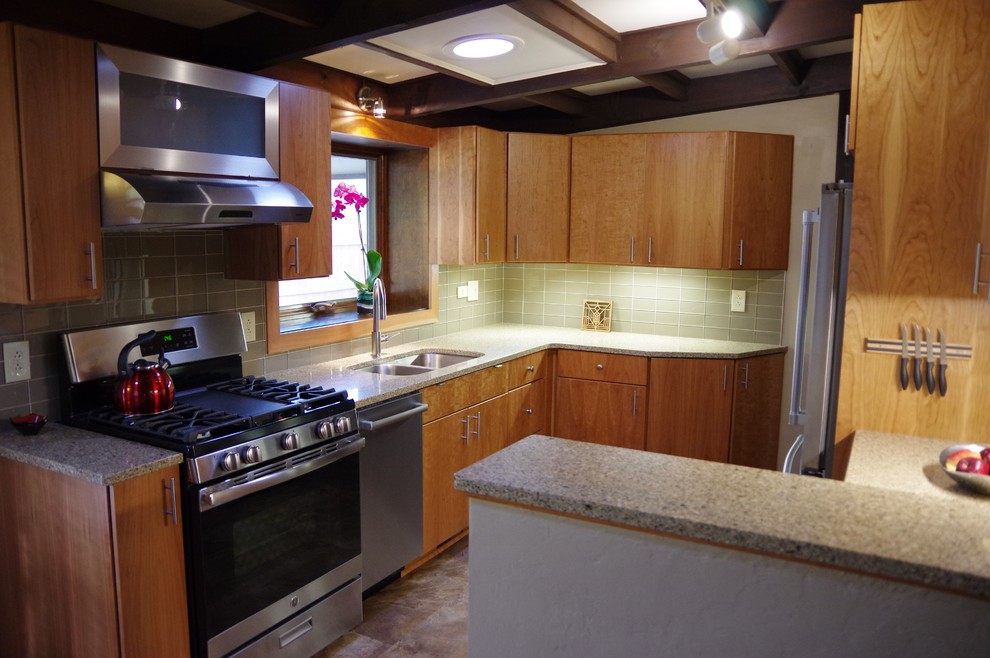 Inspiration for a small contemporary u-shaped ceramic tile and brown floor enclosed kitchen remodel with a double-bowl sink, flat-panel cabinets, medium tone wood cabinets, quartz countertops, green backsplash, subway tile backsplash, stainless steel appliances and a peninsula