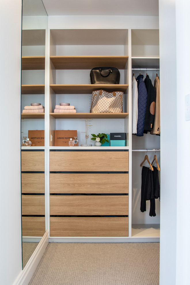 Inspiration for a contemporary gender-neutral walk-in wardrobe in Sydney with open cabinets, light wood cabinets, carpet and grey floor.