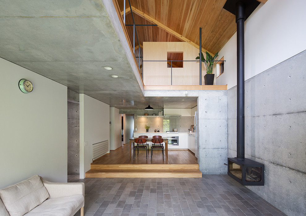 Photo of an industrial living room in Other with grey walls.