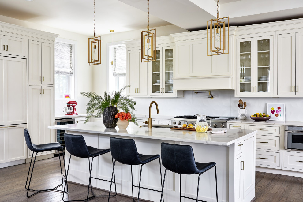 This is an example of a transitional kitchen in DC Metro with shaker cabinets, beige cabinets, marble benchtops, white splashback, ceramic splashback, with island and white benchtop.