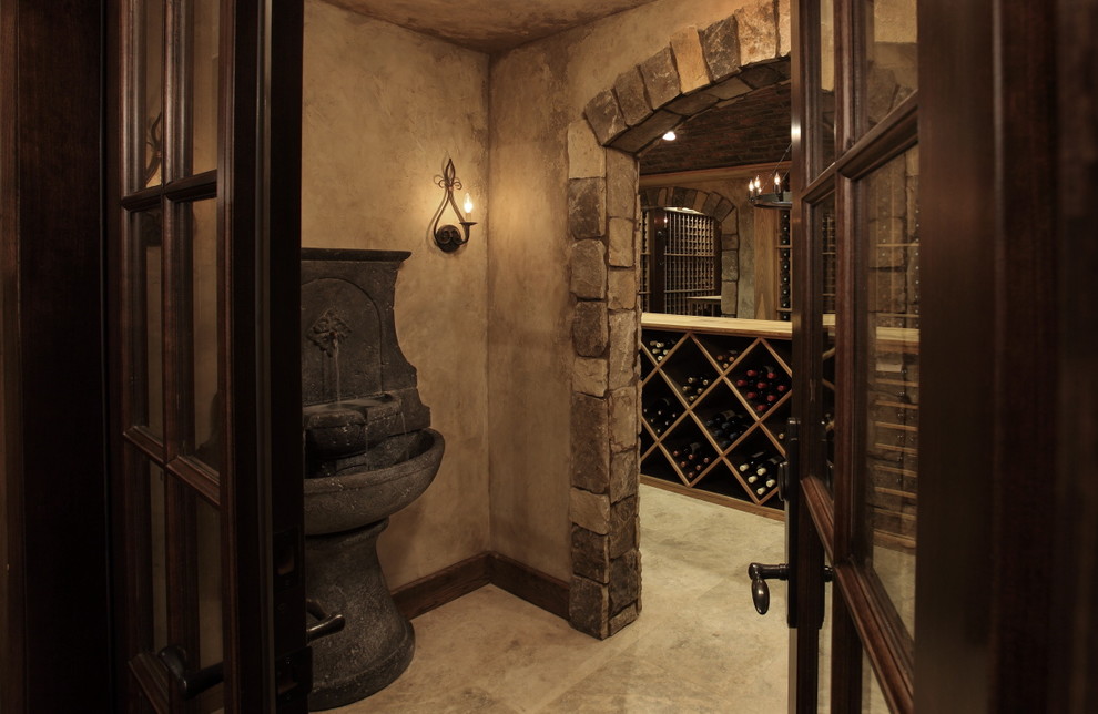 Expansive country wine cellar in Atlanta with marble floors, storage racks and beige floor.