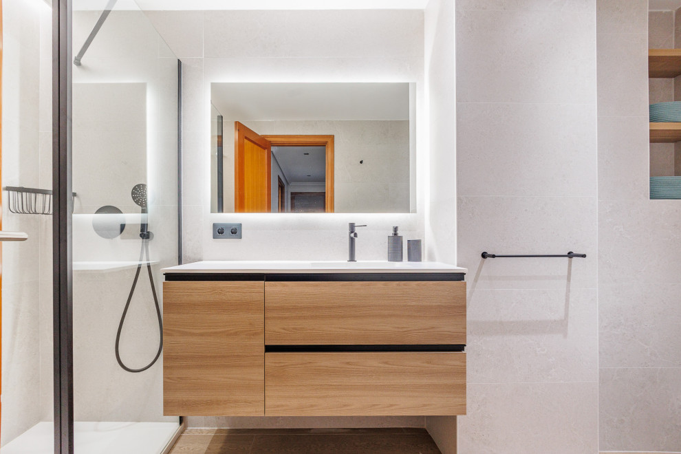Inspiration för mellanstora moderna vitt badrum, med släta luckor, vita skåp, en kantlös dusch, en vägghängd toalettstol, klinkergolv i porslin och bänkskiva i akrylsten
