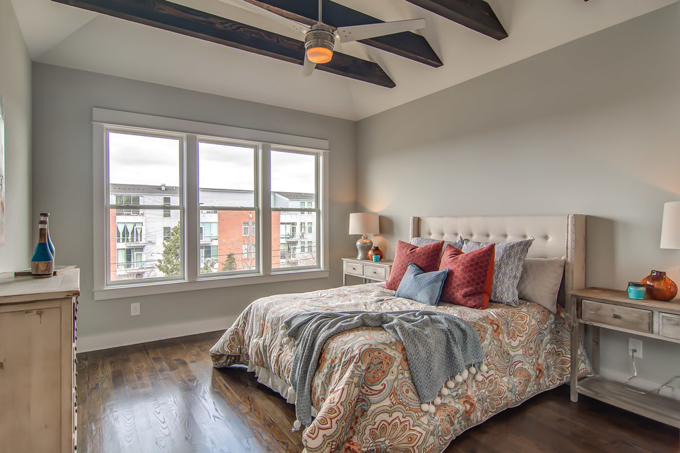 This is an example of a transitional bedroom in Nashville with grey walls and medium hardwood floors.