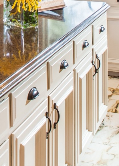 Inspiration for a large transitional u-shaped marble floor eat-in kitchen remodel in Houston with a double-bowl sink, recessed-panel cabinets, white cabinets, granite countertops, brown backsplash, stone tile backsplash, black appliances and an island