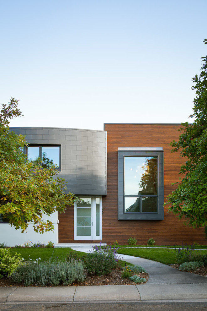 This is an example of a contemporary exterior in Denver with wood siding.