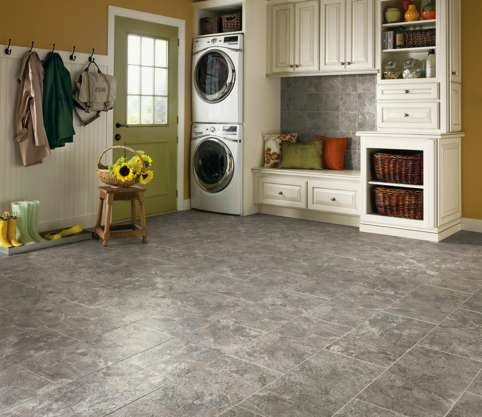 Utility room - mid-sized transitional single-wall ceramic tile utility room idea with raised-panel cabinets, white cabinets, yellow walls and a stacked washer/dryer