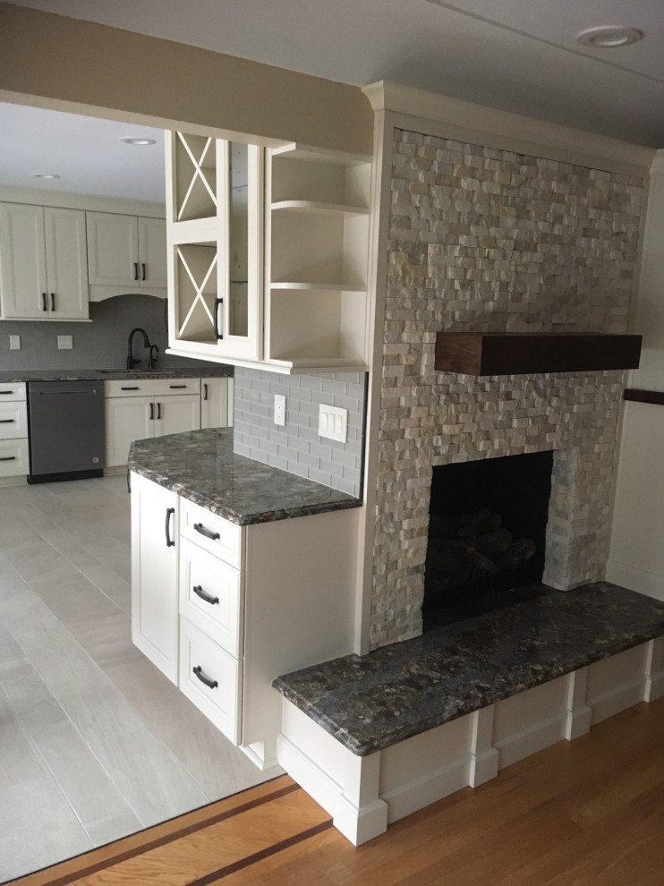 Kitchen - transitional ceramic tile and gray floor kitchen idea with an undermount sink, recessed-panel cabinets, white cabinets, gray backsplash and stainless steel appliances