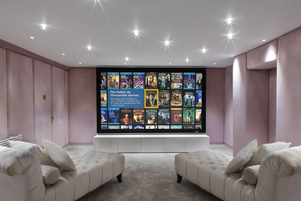 This is an example of a small contemporary enclosed home theatre in London with pink walls, carpet and a projector screen.