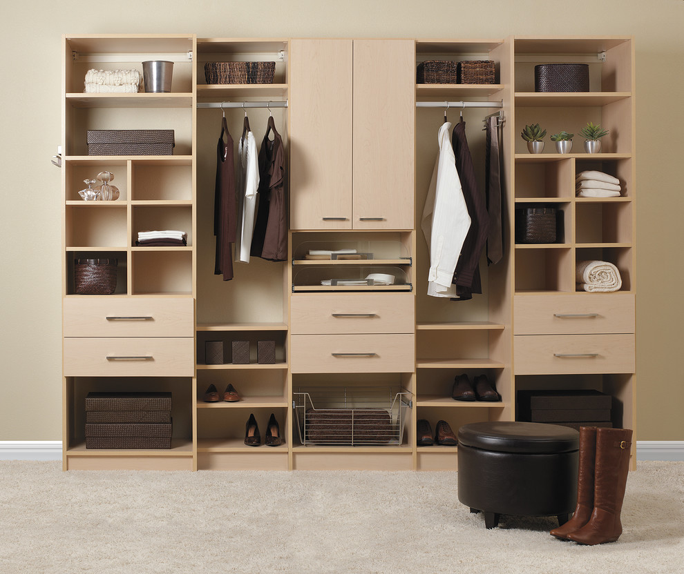This is an example of a mid-sized contemporary gender-neutral walk-in wardrobe in Tampa with flat-panel cabinets, light wood cabinets and carpet.