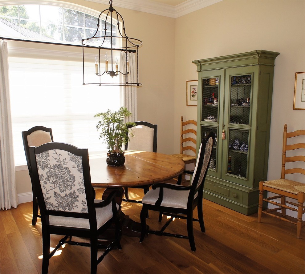 Small country dining room in San Francisco with beige walls, medium hardwood floors, no fireplace and brown floor.