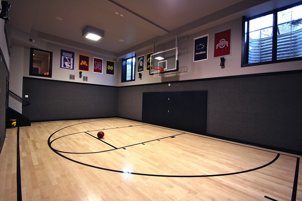 Photo of a large contemporary indoor sport court in Chicago with grey walls and light hardwood floors.