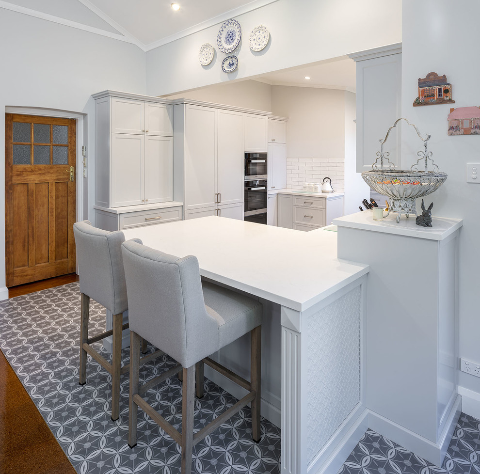 Design ideas for a traditional kitchen in Perth with shaker cabinets, white cabinets, quartz benchtops, white splashback, subway tile splashback and white benchtop.