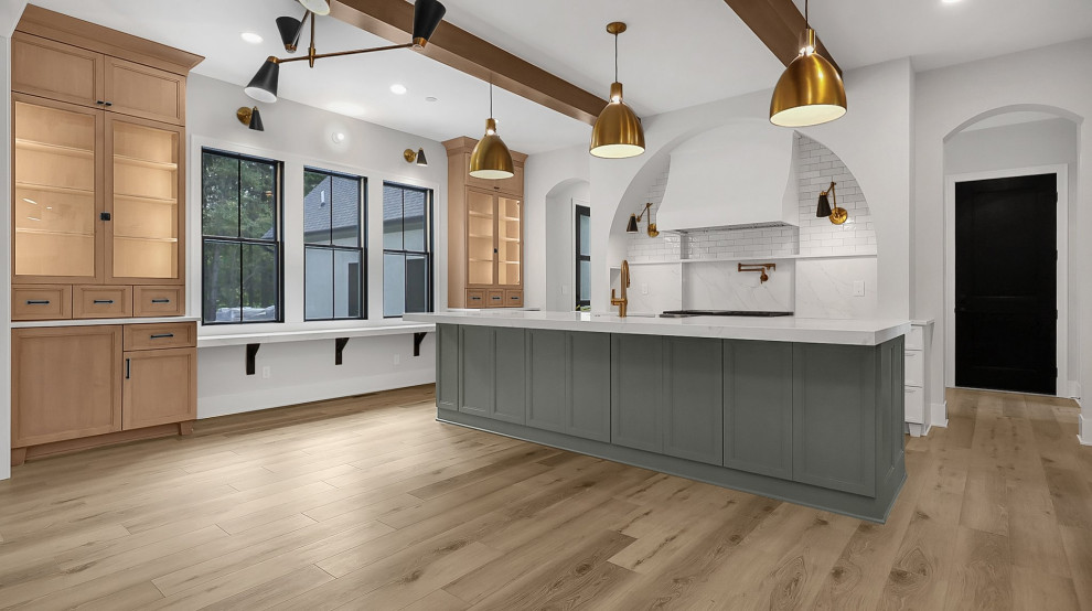 Eat-in kitchen - transitional u-shaped vinyl floor and exposed beam eat-in kitchen idea in Columbus with shaker cabinets, green cabinets, quartz countertops, white backsplash, subway tile backsplash, stainless steel appliances, an island, white countertops and a farmhouse sink