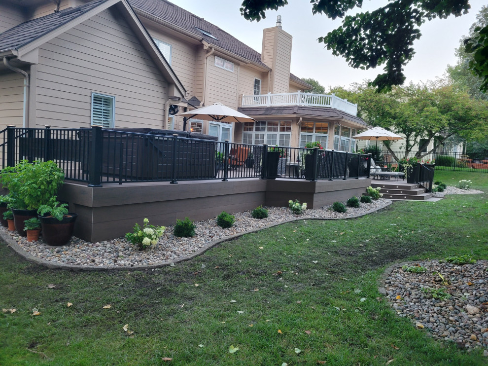 Large classic back ground level metal railing terrace in Other with no cover.