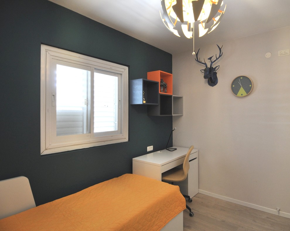 Photo of a small scandinavian kids' room for boys in Other with green walls, laminate floors and beige floor.