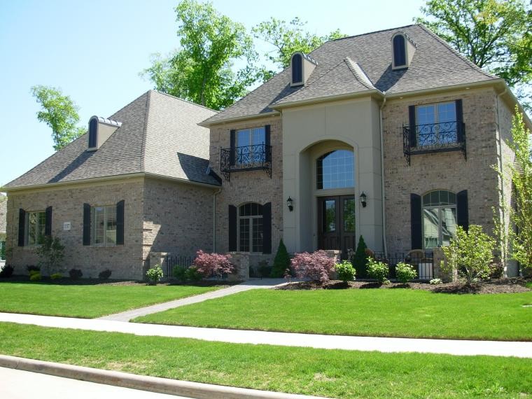 This is an example of a large traditional two-storey beige exterior in Cleveland with stone veneer.