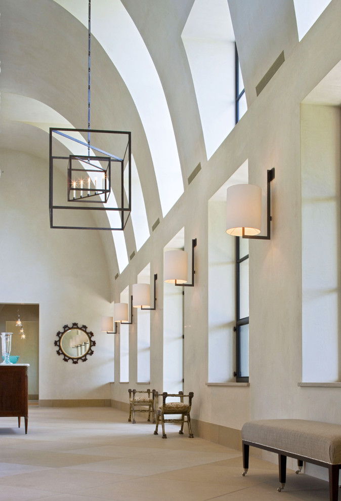 Design ideas for an expansive contemporary entry hall in Austin with beige walls and limestone floors.