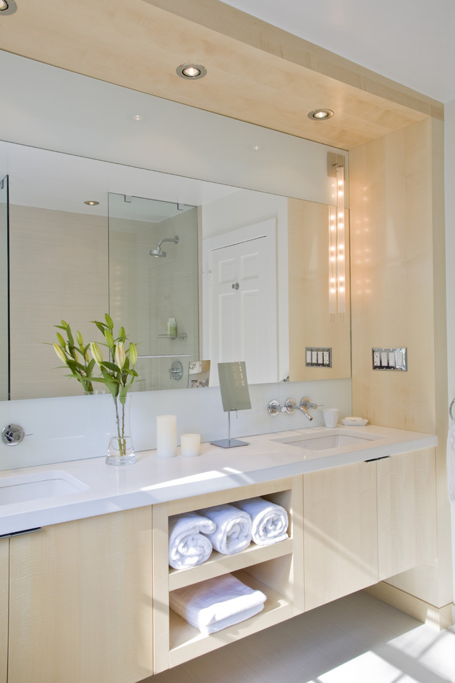 Photo of a modern bathroom in DC Metro with an undermount sink, flat-panel cabinets and light wood cabinets.