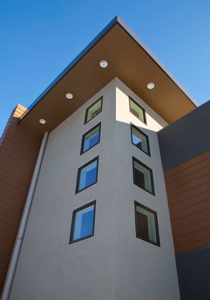 Example of a mid-sized trendy two-story stucco exterior home design in Milwaukee