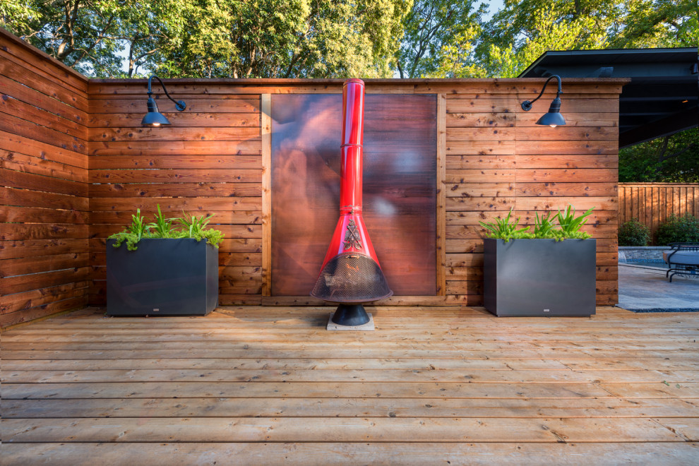 Mid-sized contemporary backyard deck in Dallas with a pergola.