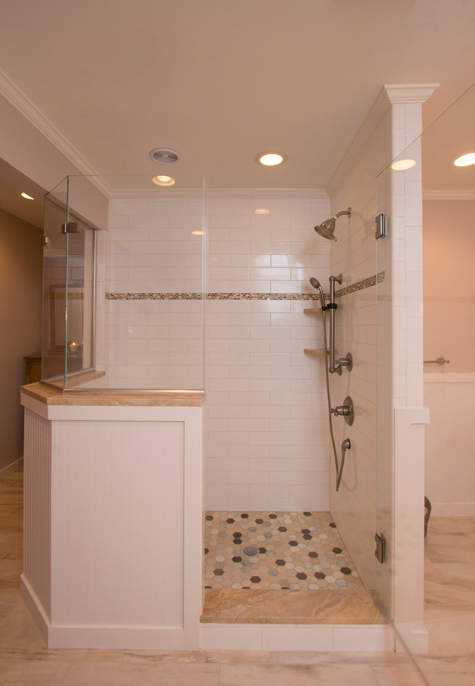 Photo of a large transitional master bathroom in Raleigh with an undermount sink, white cabinets, marble benchtops, a freestanding tub, a corner shower, a two-piece toilet, white tile, ceramic tile, beige walls, porcelain floors, shaker cabinets, multi-coloured floor, a hinged shower door and orange benchtops.