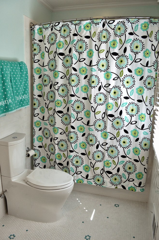 This is an example of a mid-sized transitional kids bathroom in Baltimore with a drop-in tub, a shower/bathtub combo, a two-piece toilet, white tile, ceramic tile, green walls, ceramic floors, white floor, a shower curtain, recessed-panel cabinets, white cabinets and engineered quartz benchtops.