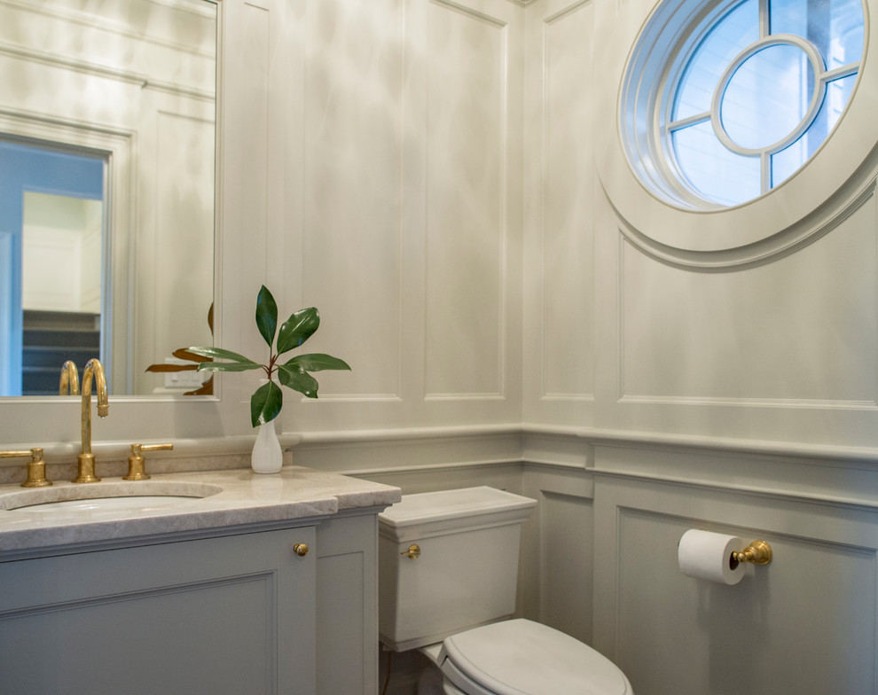 Inspiration for a small traditional powder room in Charleston with a two-piece toilet, grey walls, an undermount sink, quartzite benchtops, beaded inset cabinets, grey cabinets and beige benchtops.