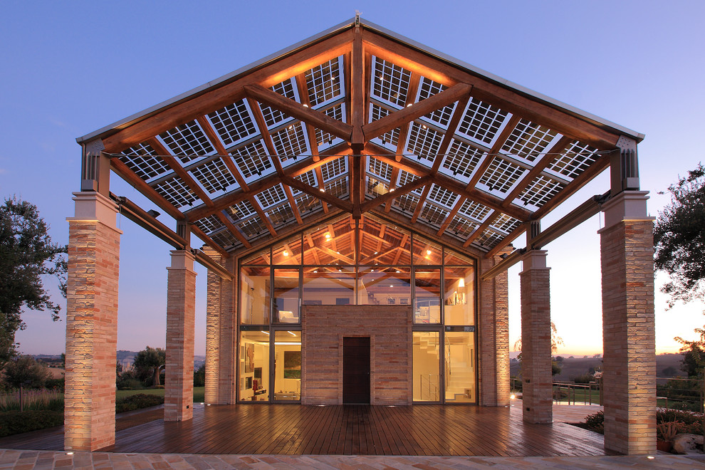 This is an example of a large country two-storey brick exterior in Other with a gable roof.