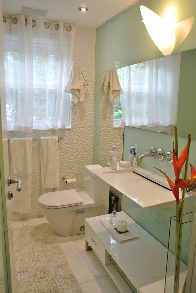 Mid-sized modern powder room in Miami with an undermount sink, open cabinets, white tile, white walls, marble floors and pebble tile.