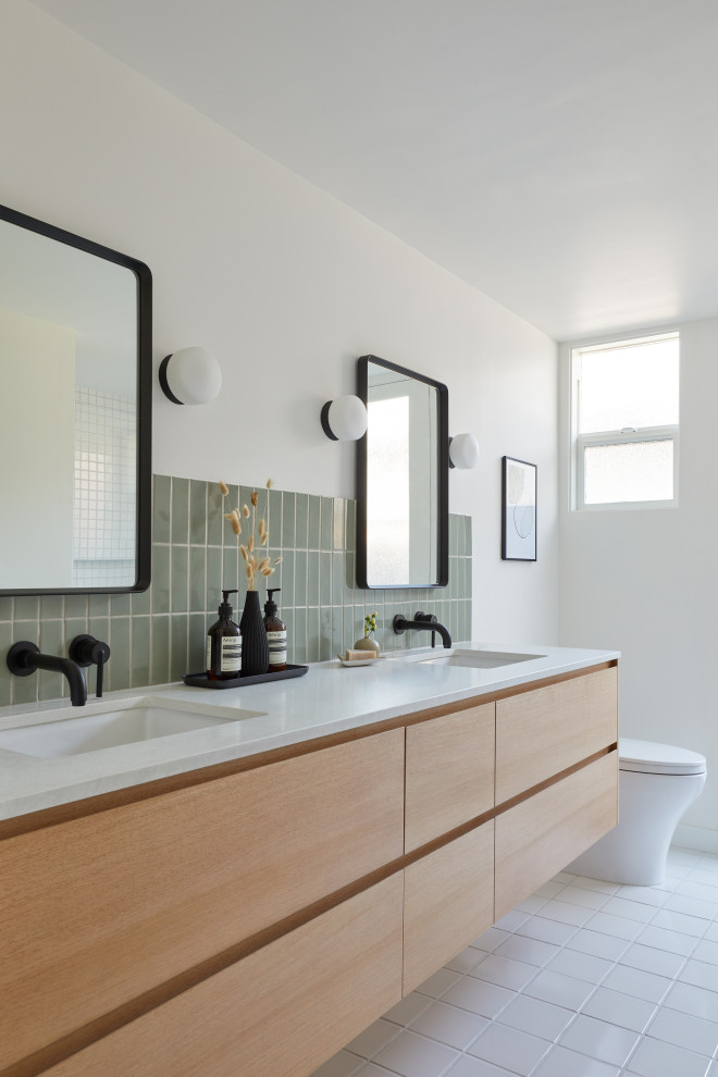 Example of a small 1950s green tile and ceramic tile ceramic tile, white floor and double-sink alcove bathtub design in San Francisco with flat-panel cabinets, brown cabinets, white walls, an undermount sink, quartz countertops, a hinged shower door, white countertops, a niche and a floating vanity