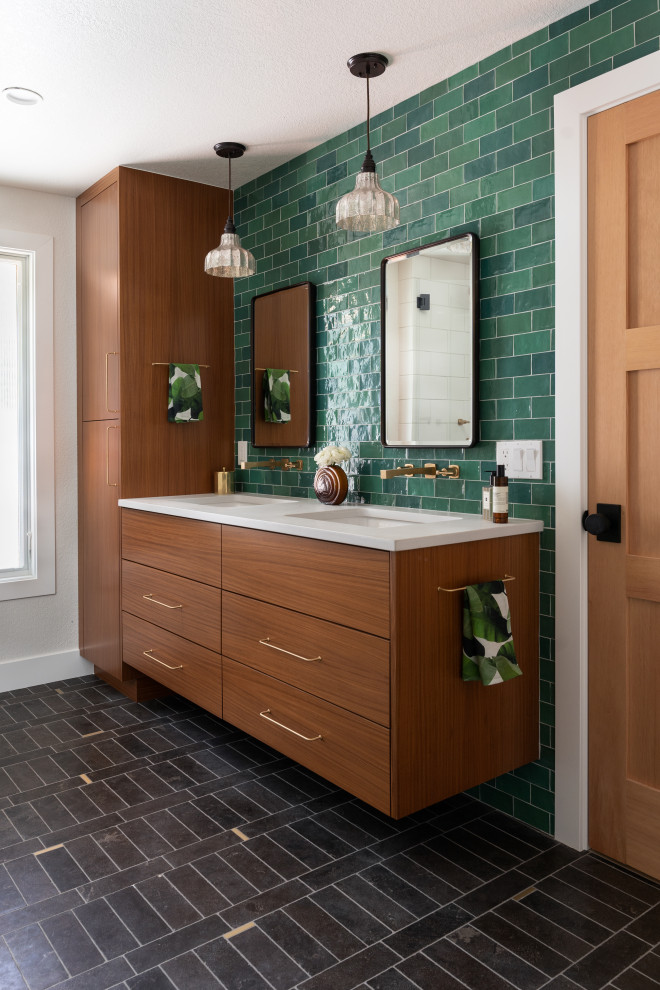 Inspiration for a mid-sized eclectic master bathroom in Denver with flat-panel cabinets, medium wood cabinets, a corner shower, green tile, ceramic tile, an undermount sink, engineered quartz benchtops, black floor, a hinged shower door, white benchtops, a niche, a double vanity and a floating vanity.