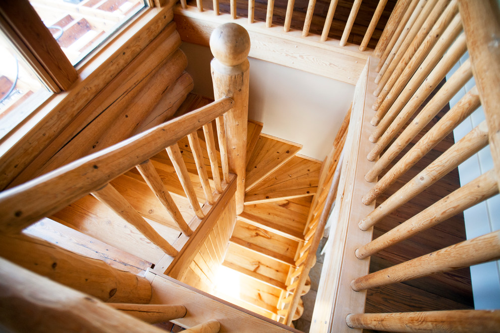 Photo of a mid-sized country wood u-shaped staircase in Vancouver with wood risers.