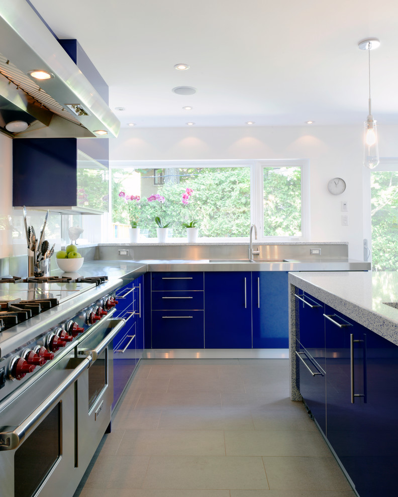 Inspiration for a contemporary kitchen in Ottawa with stainless steel appliances, an integrated sink, stainless steel benchtops, flat-panel cabinets and blue cabinets.