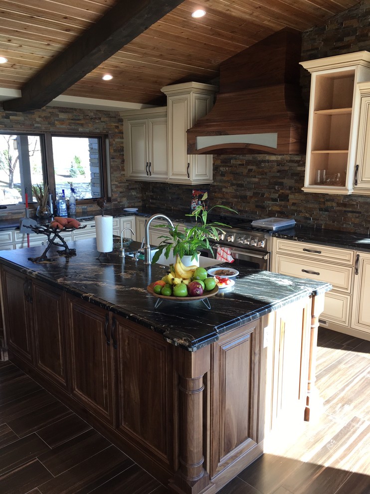 Inspiration for a huge rustic l-shaped porcelain tile open concept kitchen remodel with a drop-in sink, dark wood cabinets, granite countertops, beige backsplash, stone tile backsplash, stainless steel appliances and two islands