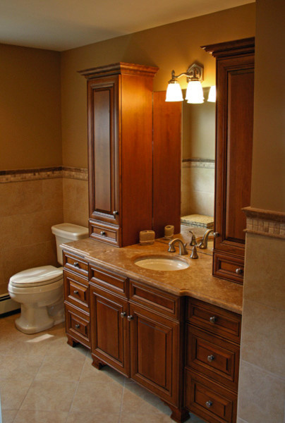 Inspiration for a mid-sized traditional 3/4 bathroom in Other with raised-panel cabinets, medium wood cabinets, a two-piece toilet, beige tile, ceramic tile, beige walls, ceramic floors, an undermount sink, engineered quartz benchtops and beige floor.
