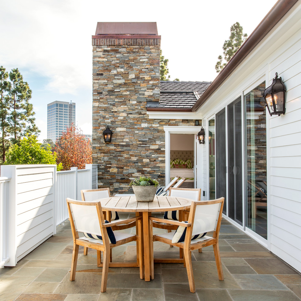 Design ideas for a mid-sized traditional backyard patio in Orange County with no cover and natural stone pavers.