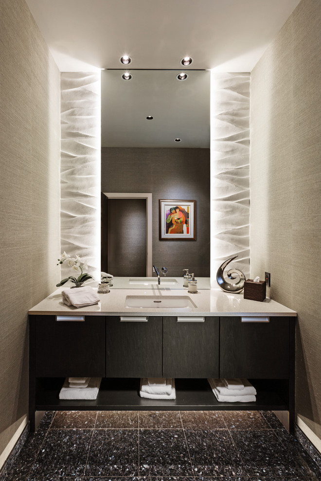 Inspiration for a small contemporary powder room in Milwaukee with an undermount sink, flat-panel cabinets, dark wood cabinets, engineered quartz benchtops, beige walls, beige tile, ceramic tile, porcelain floors, brown floor and white benchtops.