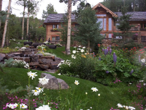 Design ideas for a huge rustic full sun backyard stone water fountain landscape in Denver.