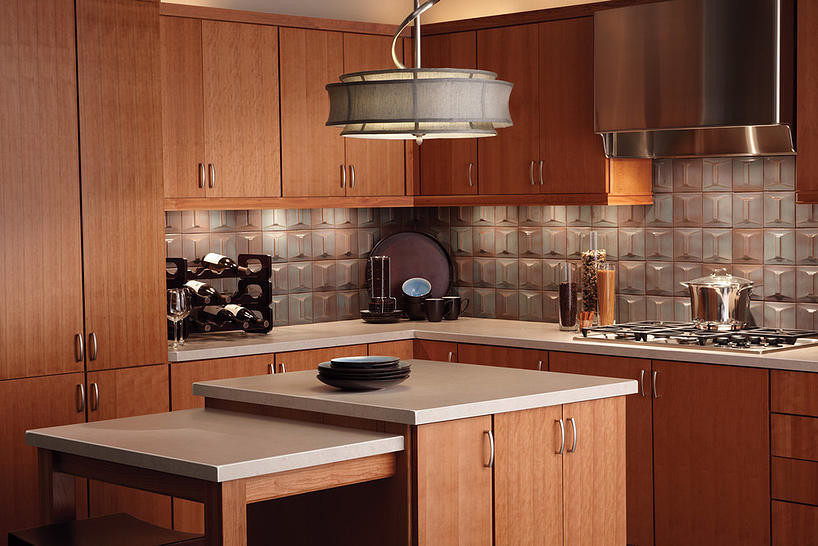 Kitchen - mid-sized transitional kitchen idea in Orlando with flat-panel cabinets, medium tone wood cabinets, quartzite countertops, metallic backsplash, stainless steel appliances and an island