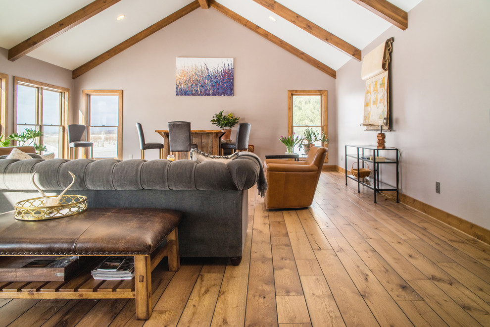 Country open concept living room in Boston with light hardwood floors.