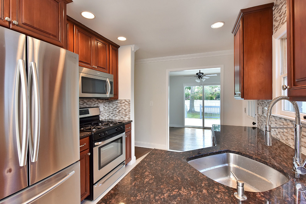 Mid-sized transitional galley kitchen photo with a single-bowl sink, raised-panel cabinets, medium tone wood cabinets, gray backsplash, stainless steel appliances and no island