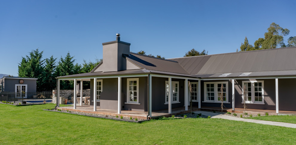 Inspiration for a large country front yard verandah in Other with decking, a roof extension and with columns.