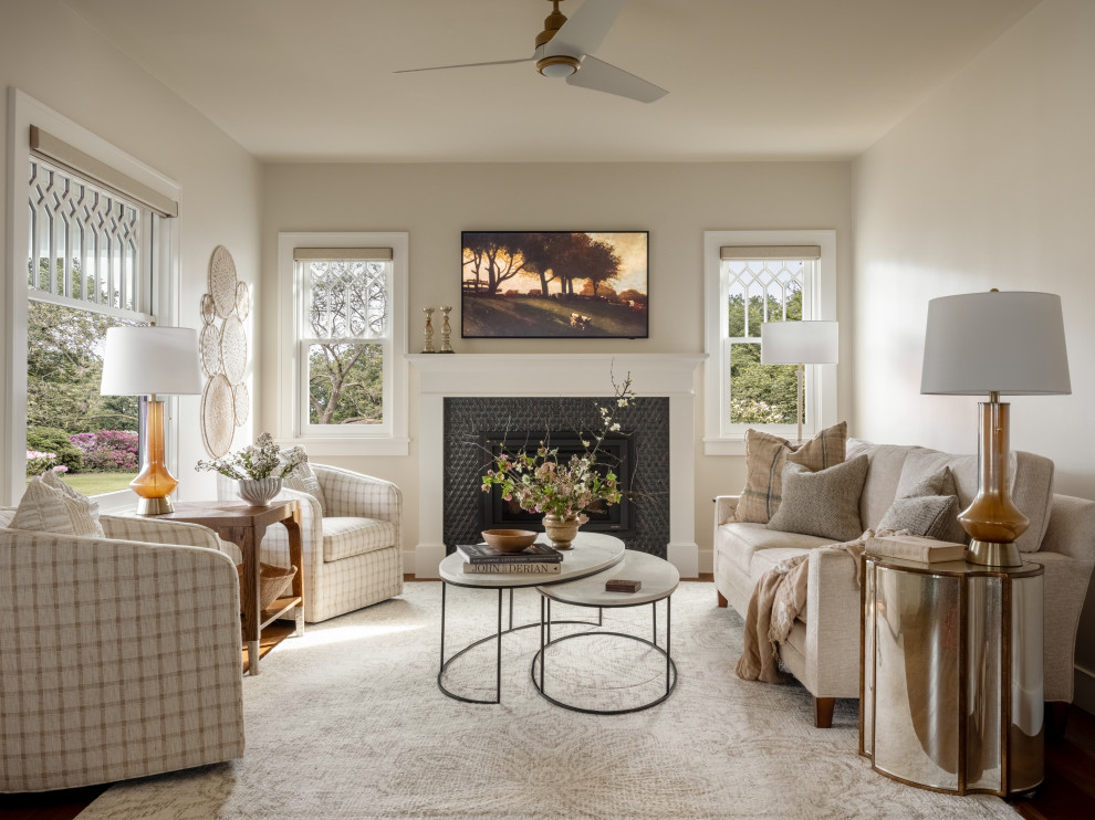 Example of a mid-sized transitional dark wood floor, brown floor, tray ceiling and wainscoting living room design in Seattle with white walls, a standard fireplace, a tile fireplace and a wall-mounted tv