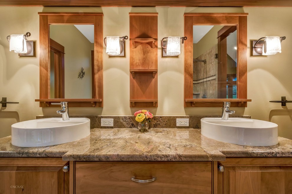 Master marble floor and beige floor bathroom photo in Seattle with medium tone wood cabinets, granite countertops, a one-piece toilet, beige walls, a vessel sink and raised-panel cabinets